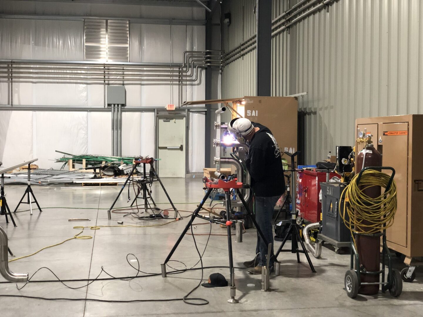 A group of people standing around in an industrial setting.