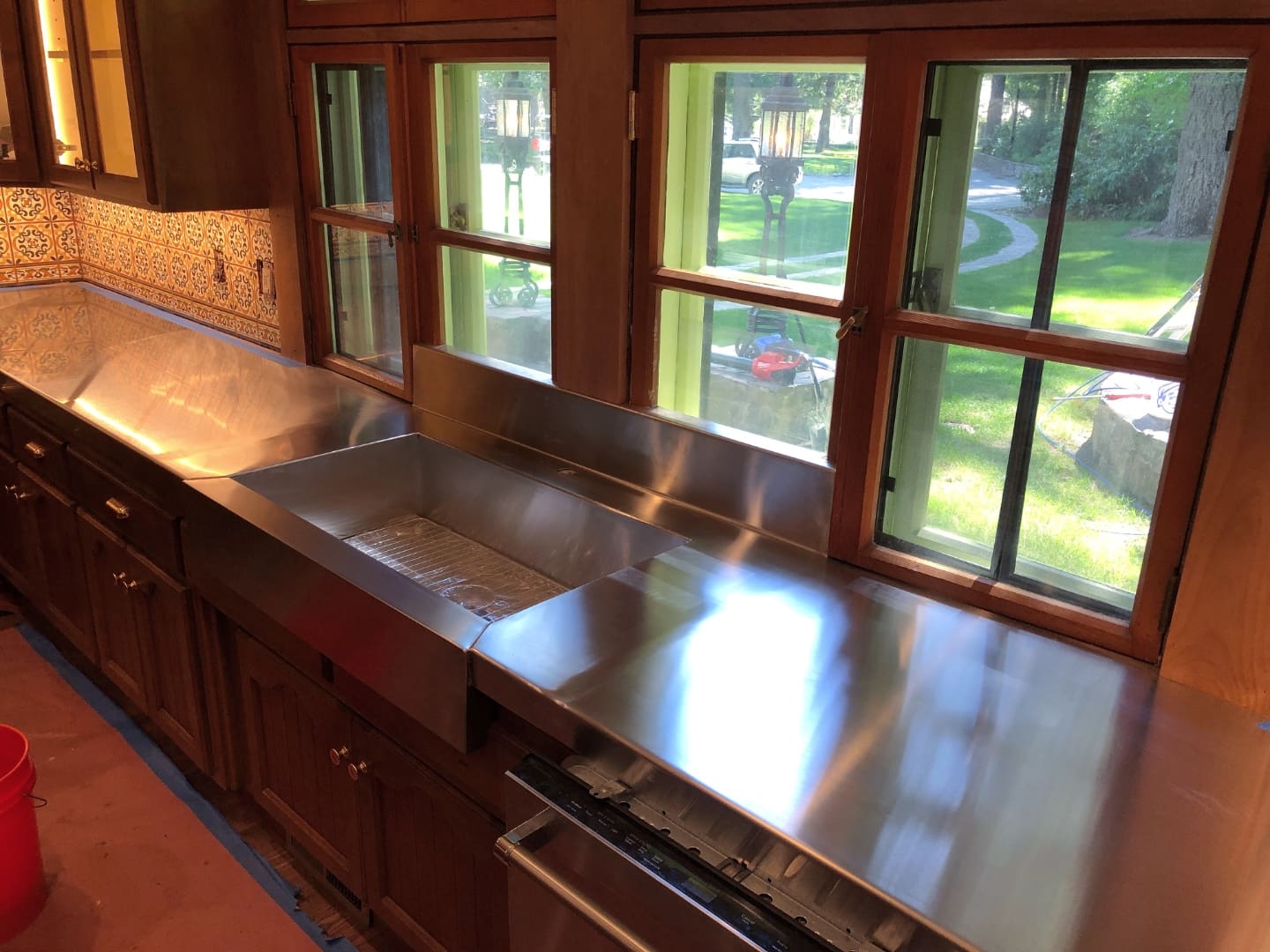 Custom stainless steel countertop and farmhouse sink installation - SAI