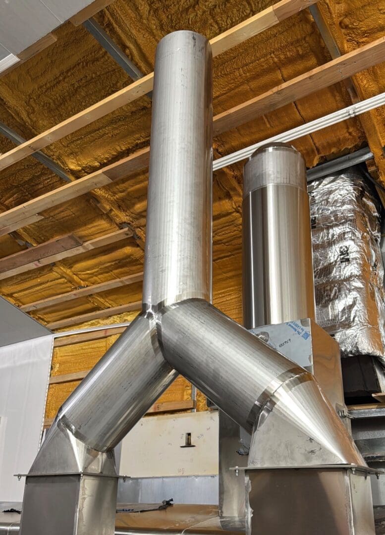 Custom all-welded stainless sanitary steam slip stack fabricated by Stainless Aesthetics Inc