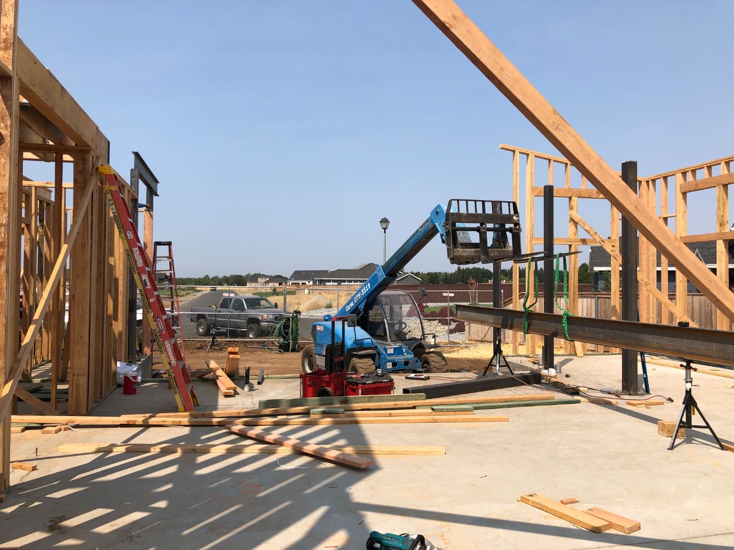 Structural steel I-beam installation during residential construction - SAI